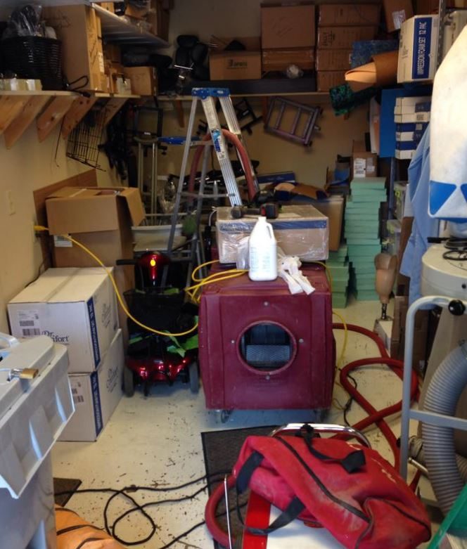 Air scrubber or negative-air machine with flexible ducting set up in a cluttered garage